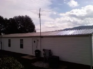 New metal roof on a single wide mobile home with a TV antenna in Union City