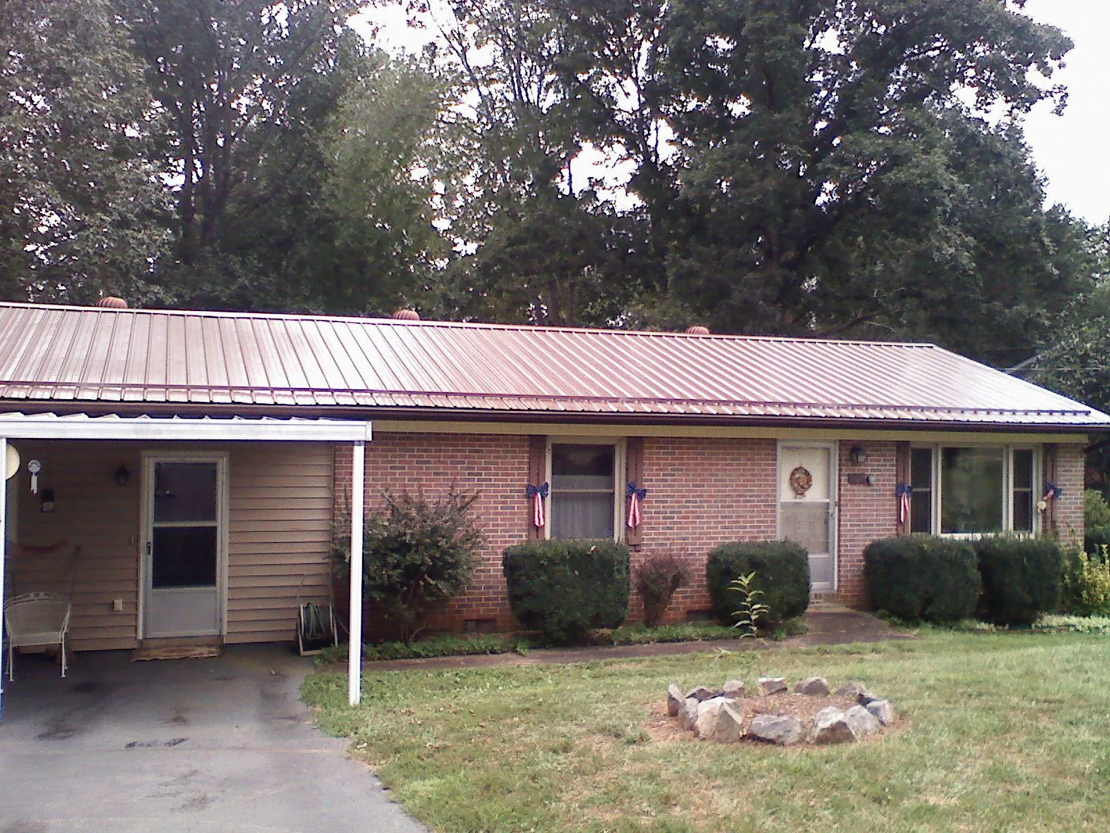 Bronze metal roof and carport on a brick ranch home — Roof Repair work by our crew in Union City