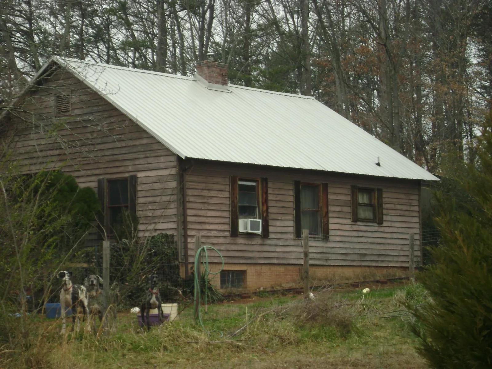 White metal roof on an old wood sided farmhouse, from a Asphalt Shingle Roof Repair job in Union City